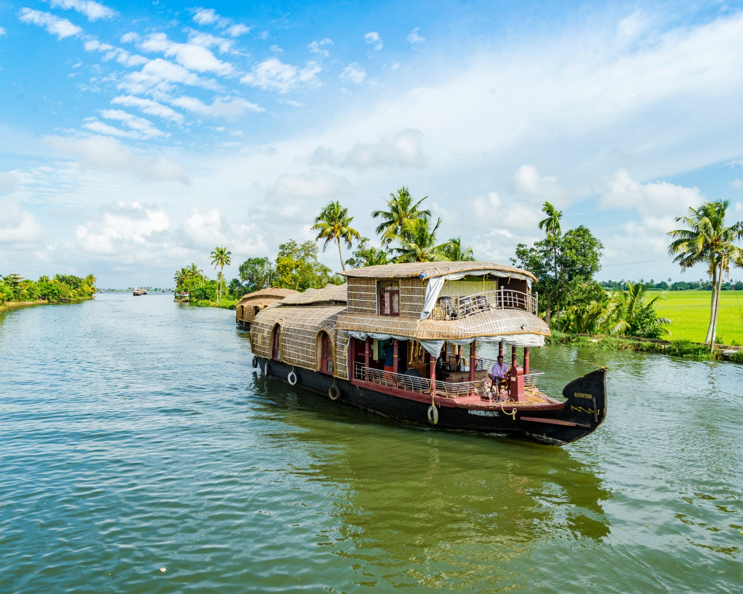 Traditional Kettuvallam houseboat navigating Alleppey backwaters