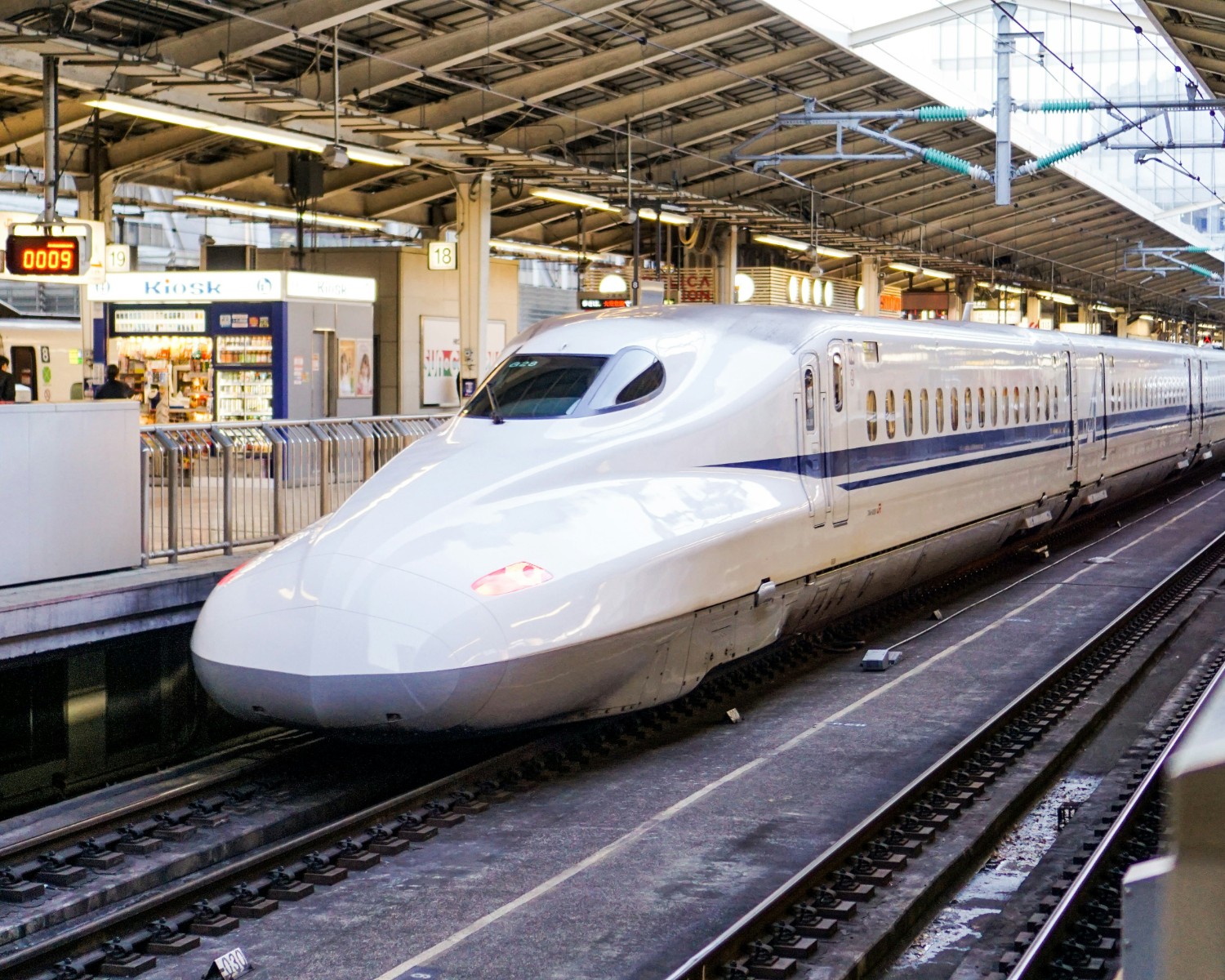 Shinkansen bullet train speeding past Mount Fuji