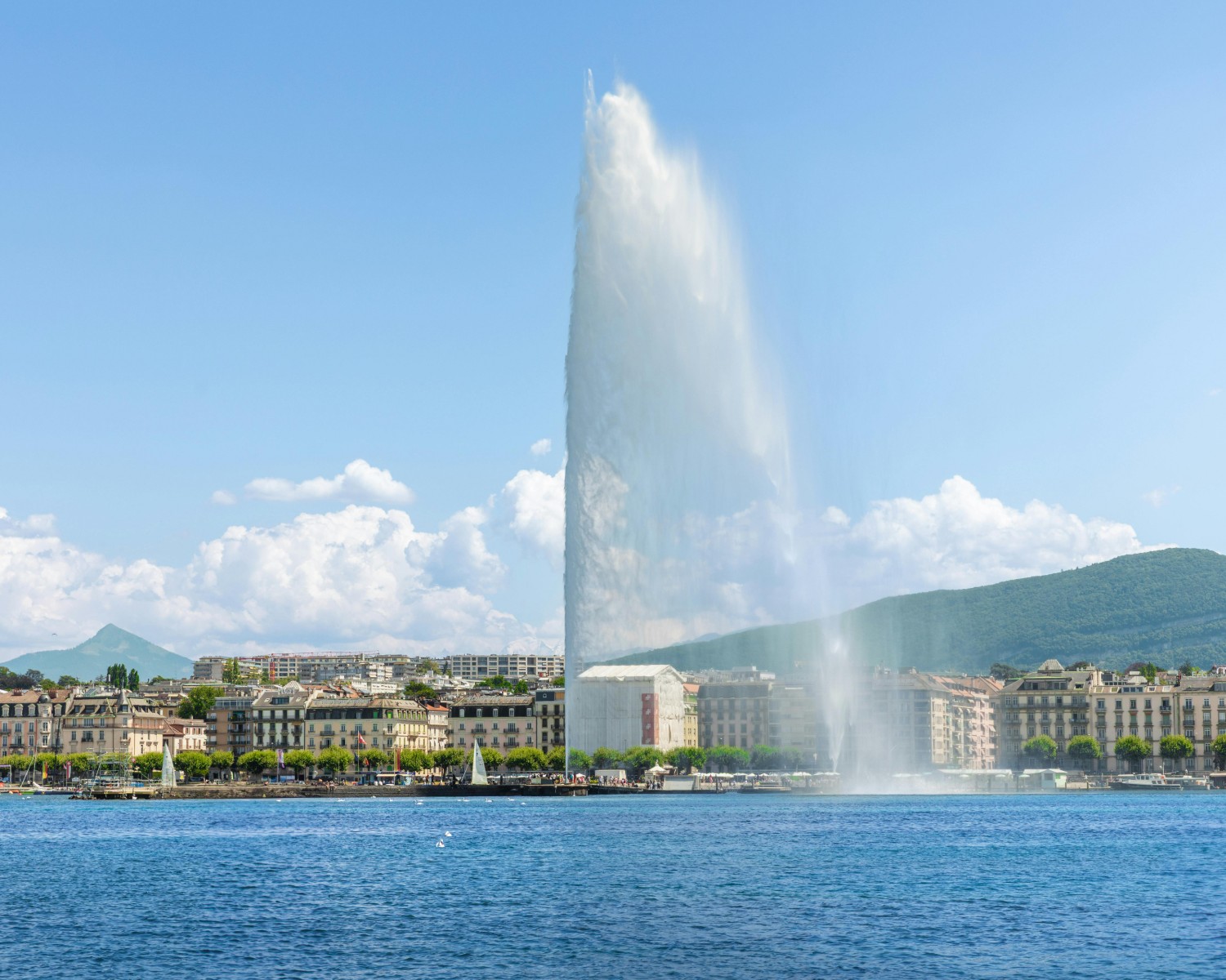 Geneva's Lake Geneva (Lac Léman) with iconic Jet d'Eau fountain and Alps beyond