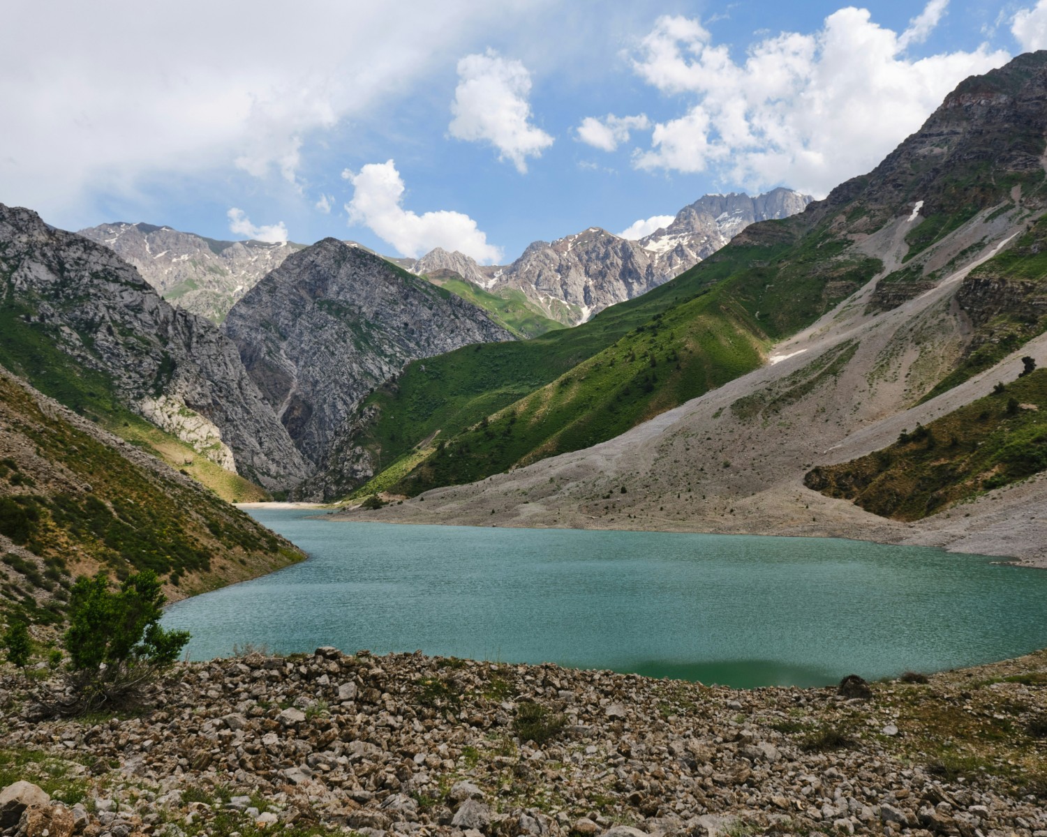 Big Almaty Lake's turquoise waters framed by snow-capped mountains